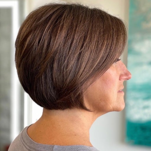 How can bangs complement hairstyles for women over 50 with fine hair?