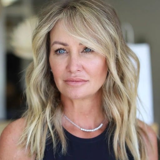 How can medium-length hairstyles flatter women over 50 with fine hair?